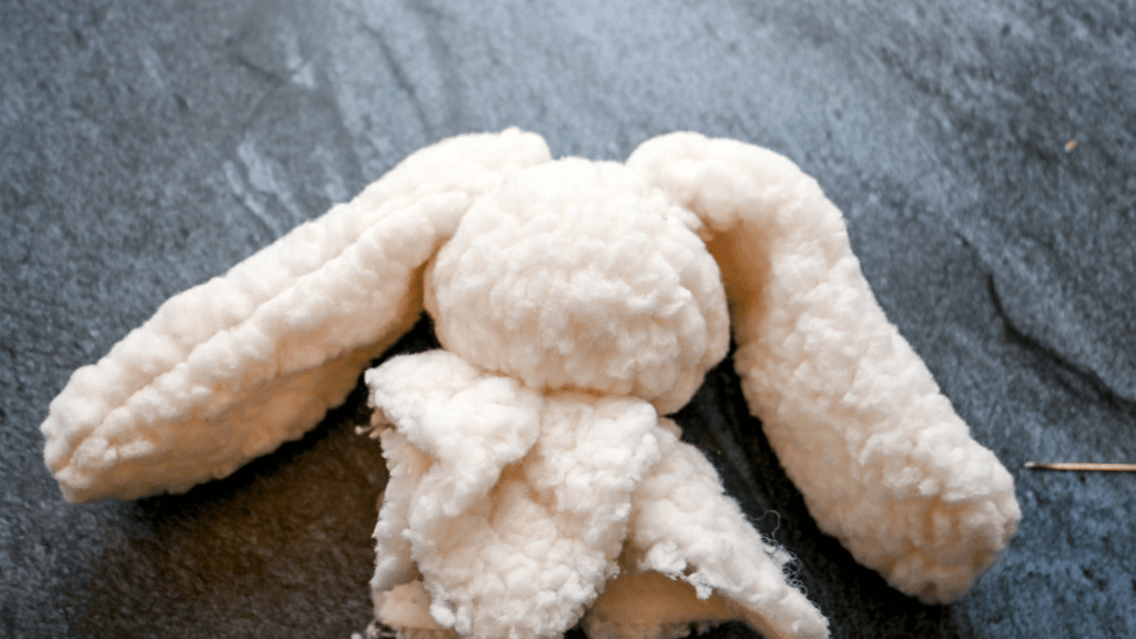 The head of the Snuggle Bunny Lovey Doll with ears pinned in place. 