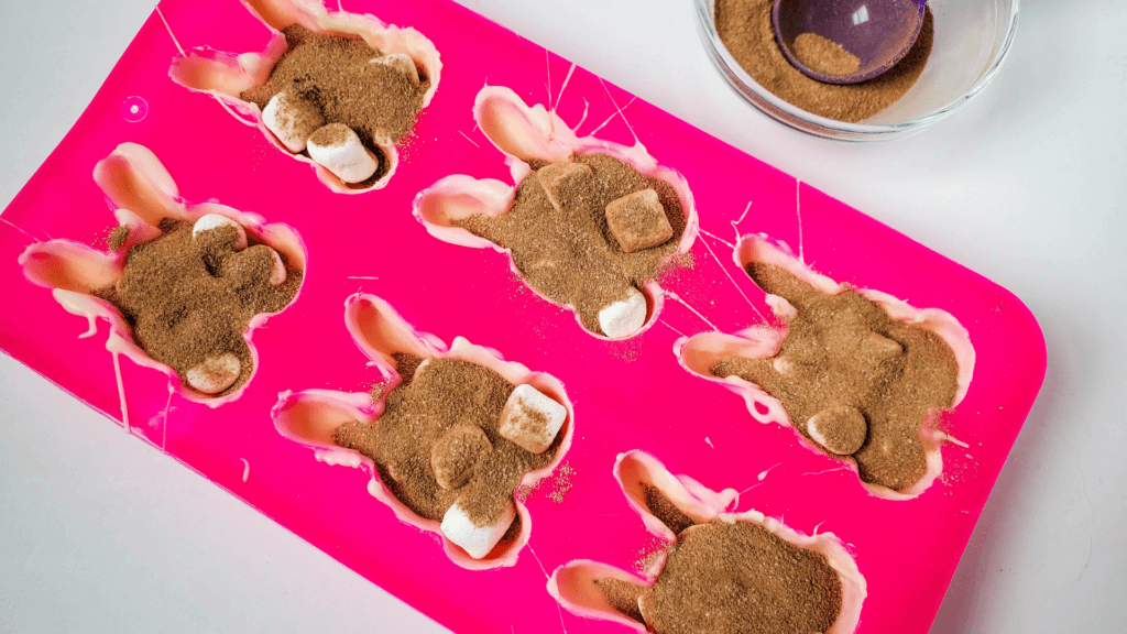 Adding hot cocoa mix to the Easter Bunny Hot Cocoa Bombs.