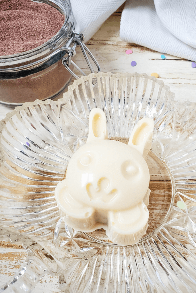 Finished Easter Bunny Hot Cocoa Bomb on a crystal plate.