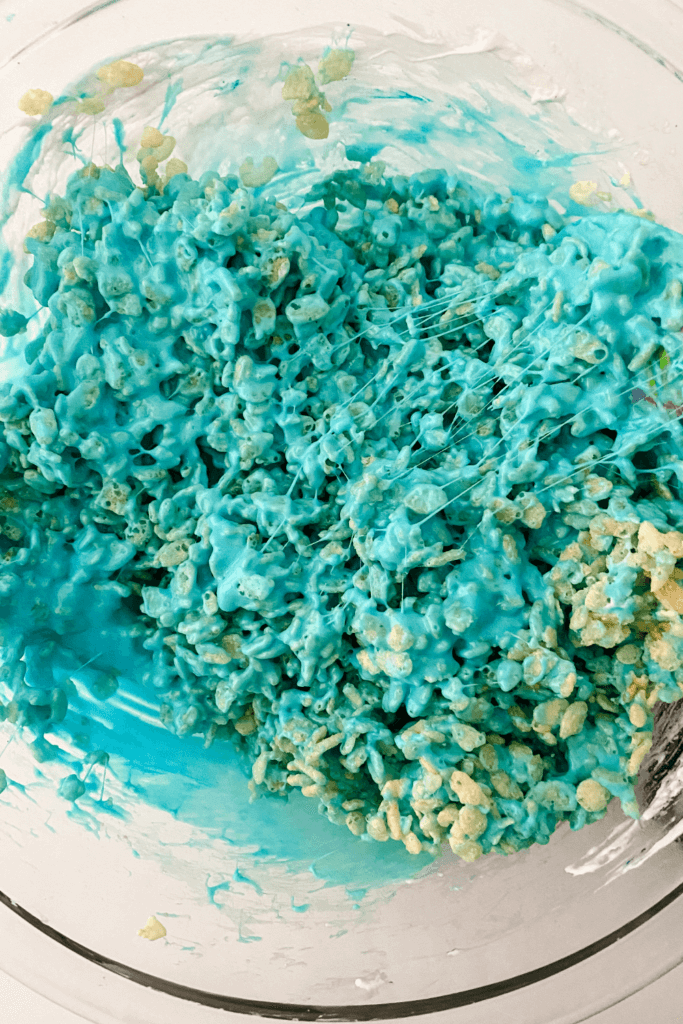 Mixing the Rice Krispies and blue marshmallow goo.