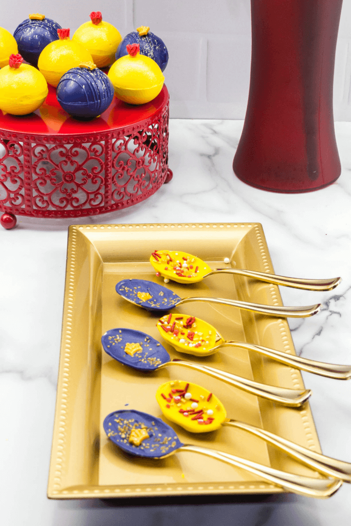 The finished Disney Inspired Beauty & the Beast Chocolate Spoons on a gold platter.