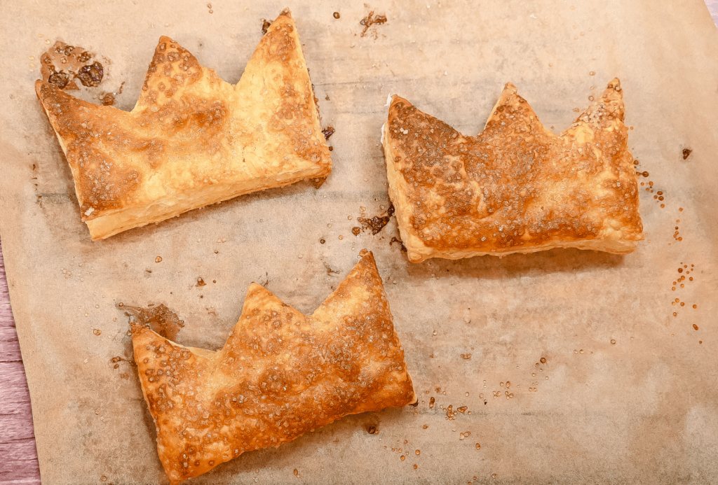 Freshly baked Puff Pastry Cream Cheese Tiara Tarts from the oven on brown parchment paper