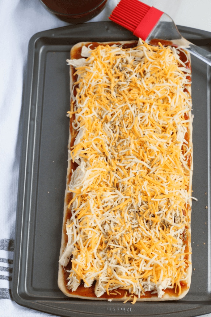 BBQ Chicken Flatbread pizza with shredded cheese.