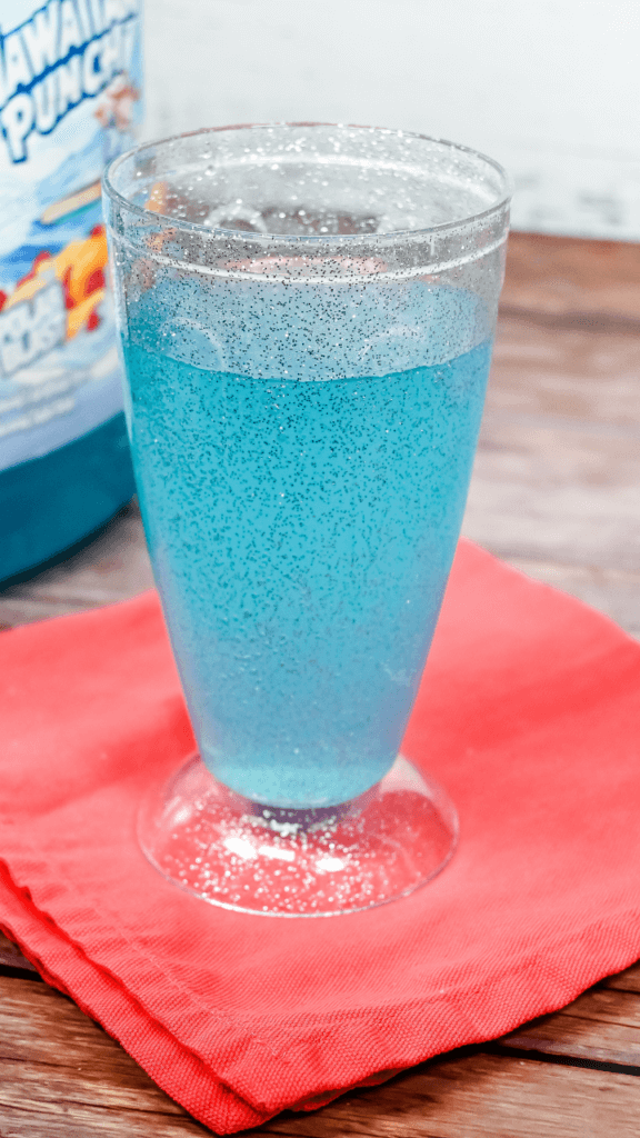 Glitter glass full of Blue Hawaiian Punch and Lemon Lime Soda. 