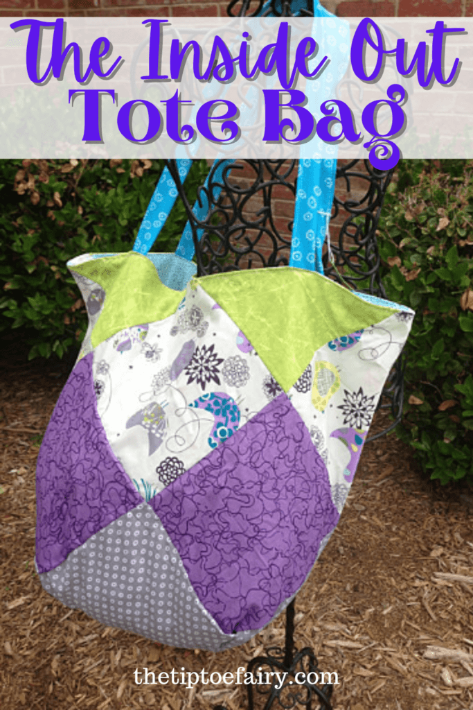 Title image for The Inside Out Tote Bag with a purple and gray bag hanging on a dress form in a flower bed. 