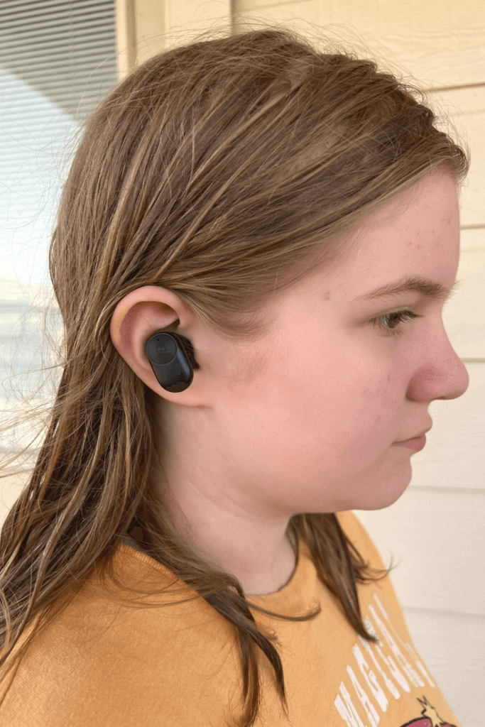 A tween girl wearing a PaMu Slide 2 ANC Wireless Earbud