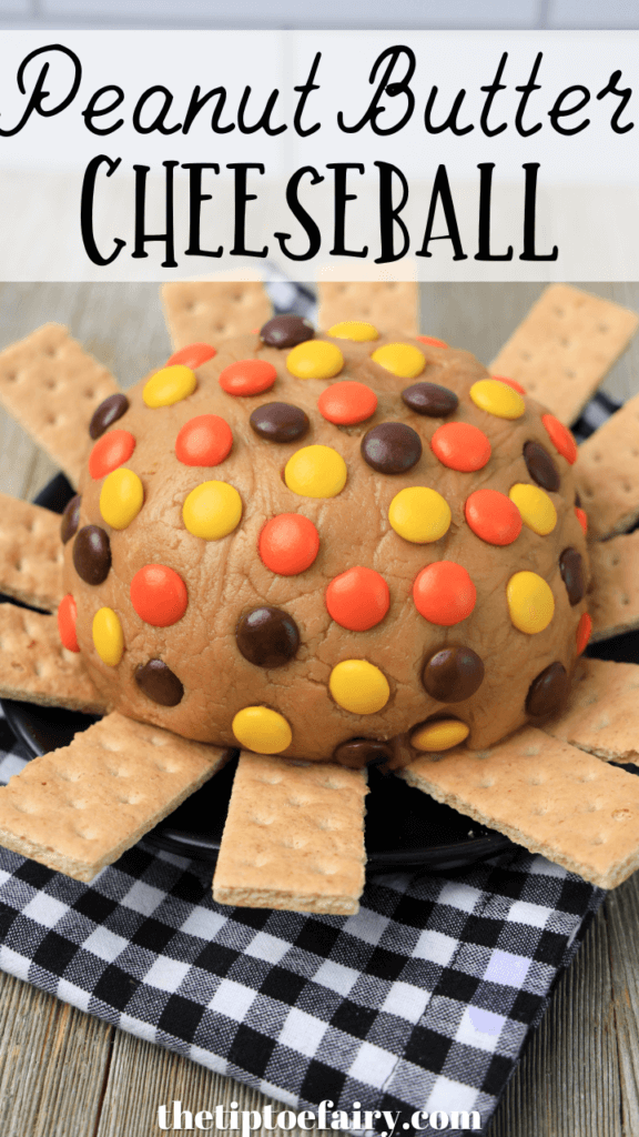Title image with a close up of the Reese's Pieces Peanut Butter Cheeseball surrounded by graham crackers. 