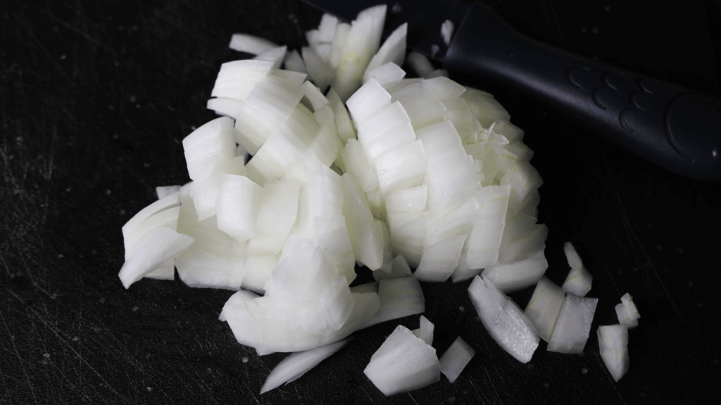 Diced onions on a black plate. 
