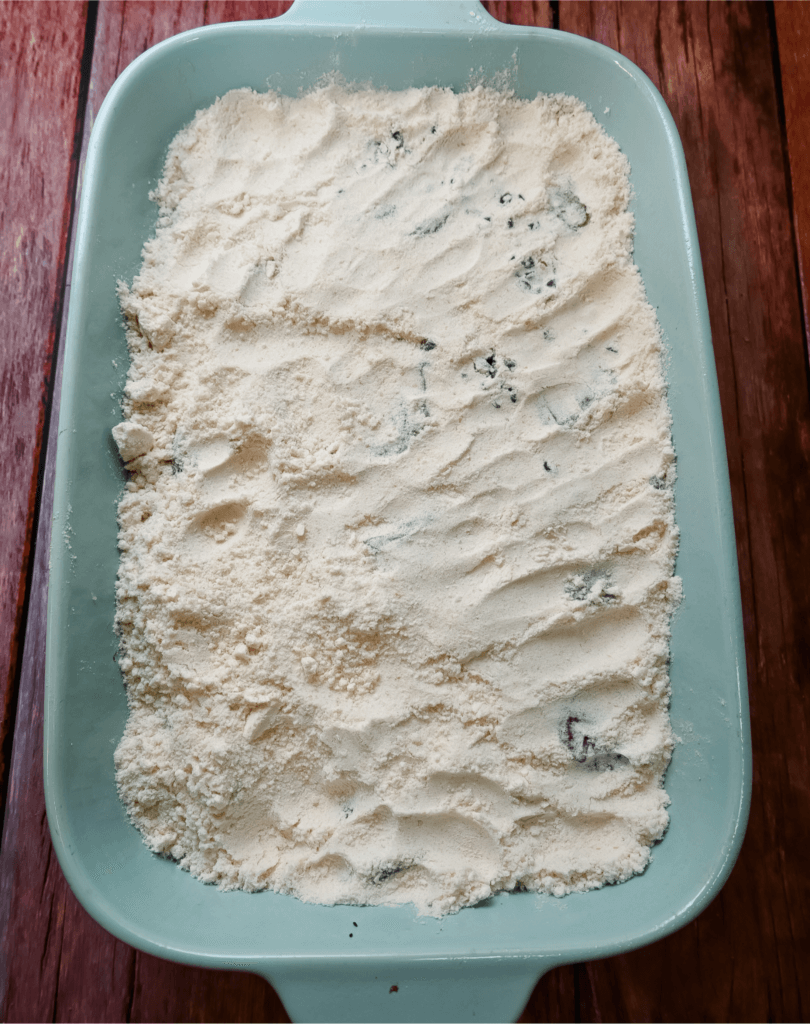 Banana bread mix in the blue casserole dish. 