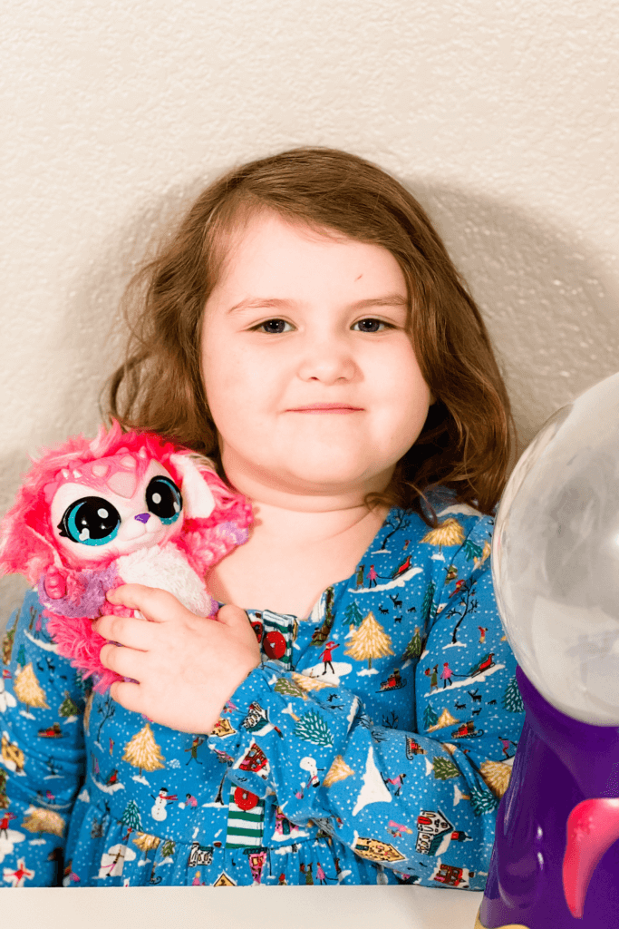 Close up of a little girl holding her Magic Mixie next to the Crystal Ball