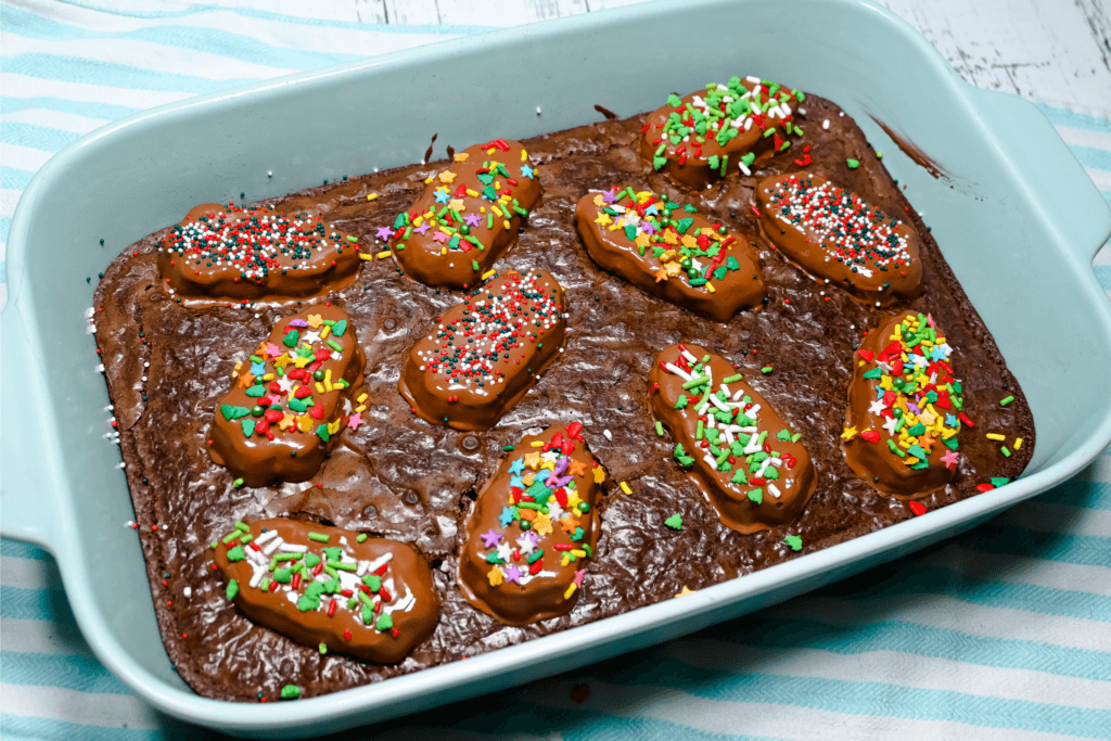 The brownies in the light blue pan with the Reese's Trees on top with sprinkles on each Tree. 