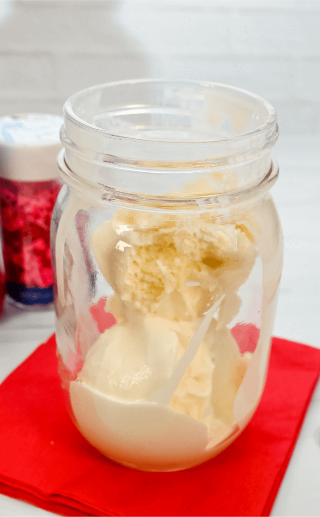 Mason jar glass with scoops of vanilla ice cream