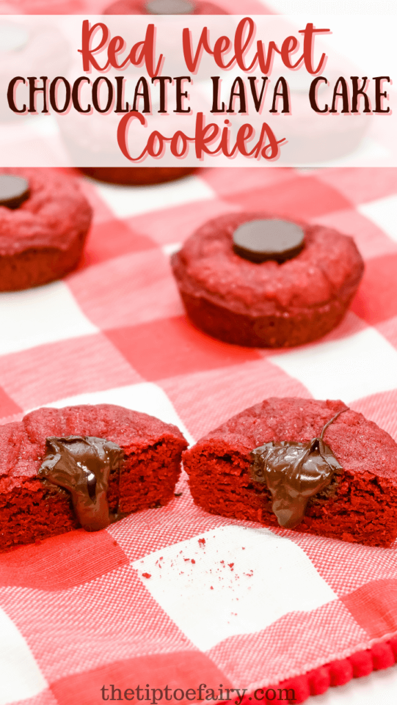 Close up of Red Velvet Chocolate Lava Cake Cookies on a red plaid placemat with one cookie cut in half and the chocolate oozing down. 
