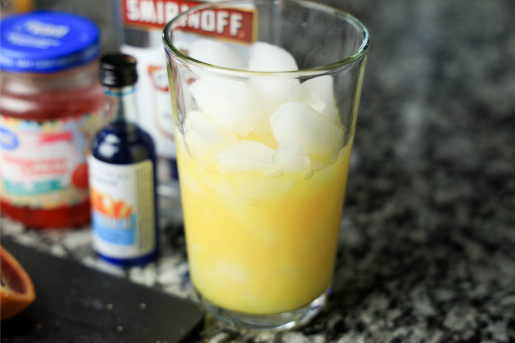 orange juice and ice in a glass 