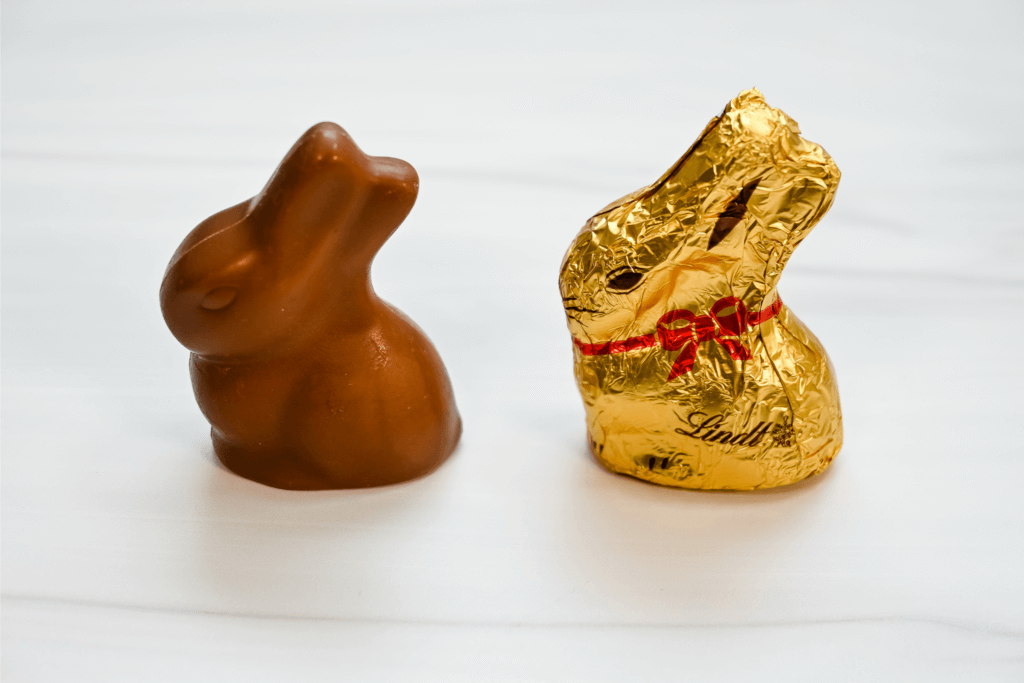 A wrapped and an unwrapped Lindt chocolate bunny