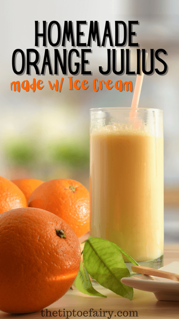 A homemade Orange Julius in a glass with a straw next to some fresh oranges