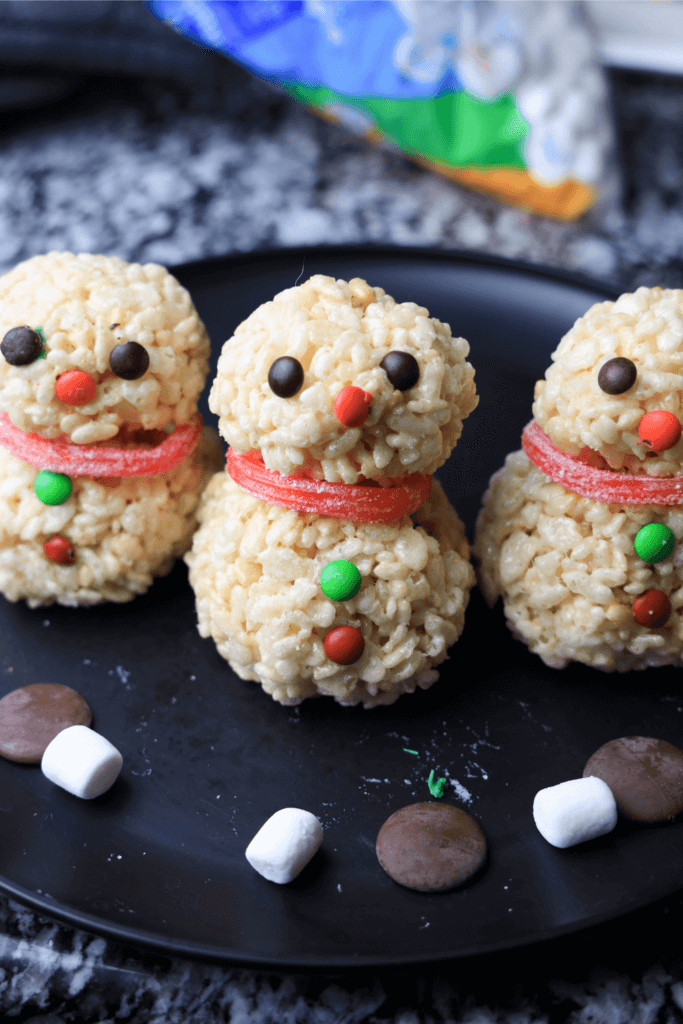 Decorating the snowman rice krispies treats