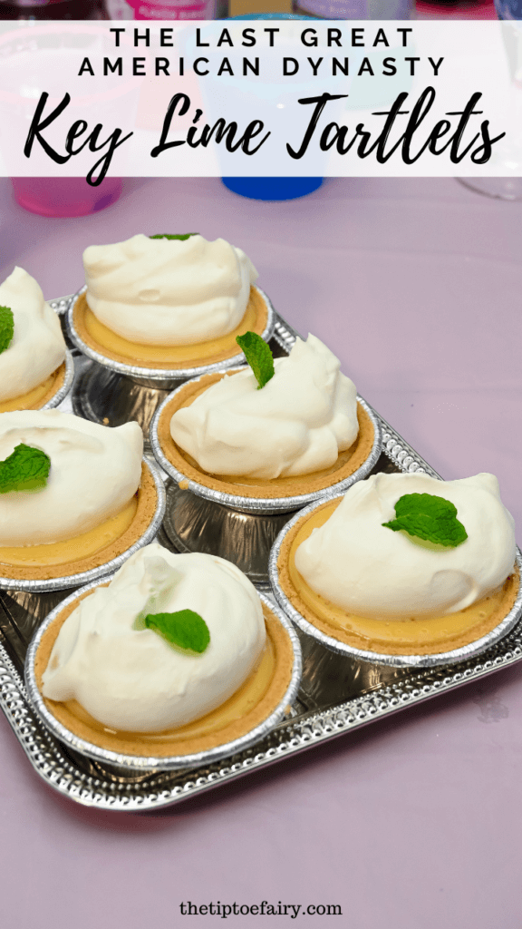A silver pan of six key lime tartlets on a table