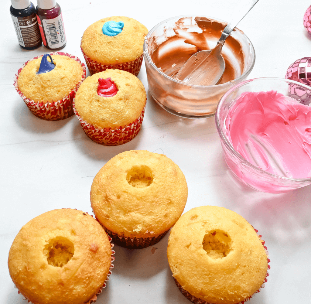 Adding the frosting to the center of each cupcake