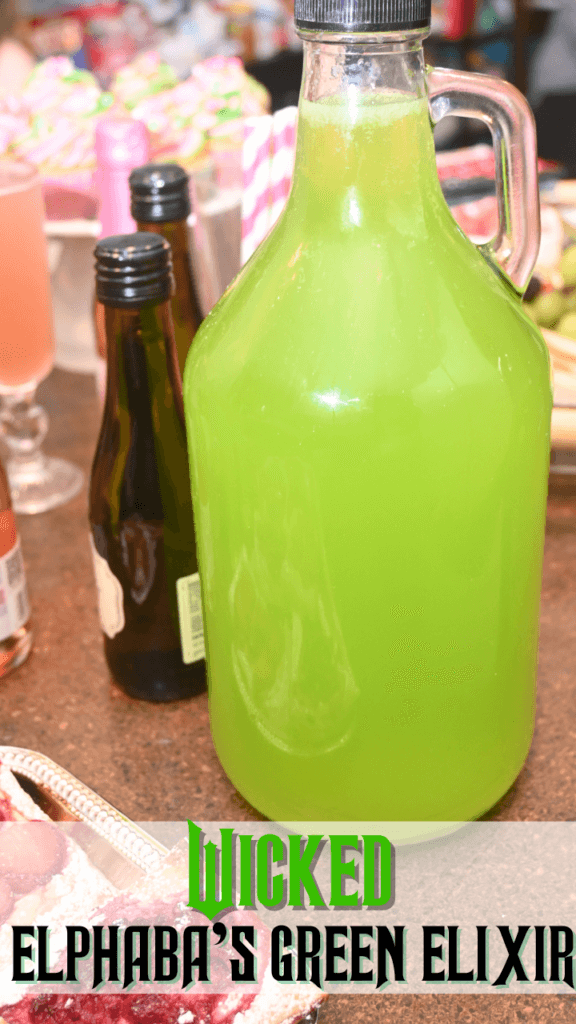 Title image with a jug of Elphaba's Green Elixir next to some berry tarts.