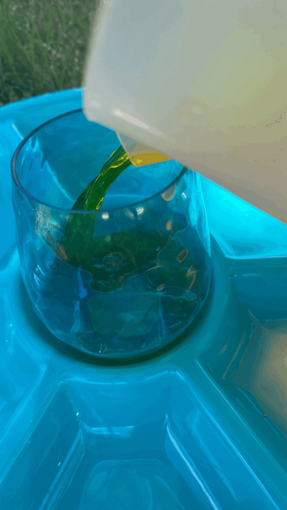 Adding yellow water to a glass as "flower nectar."
