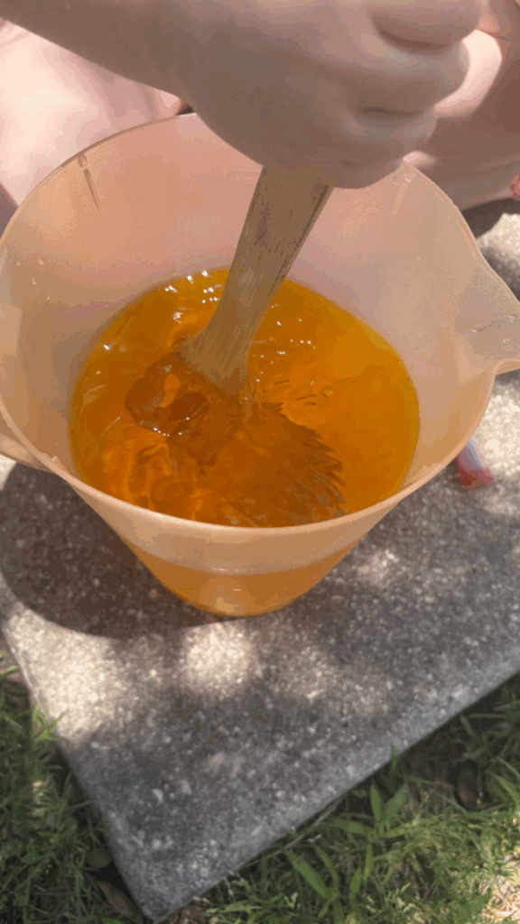 Mixing the yellow dye into the water.