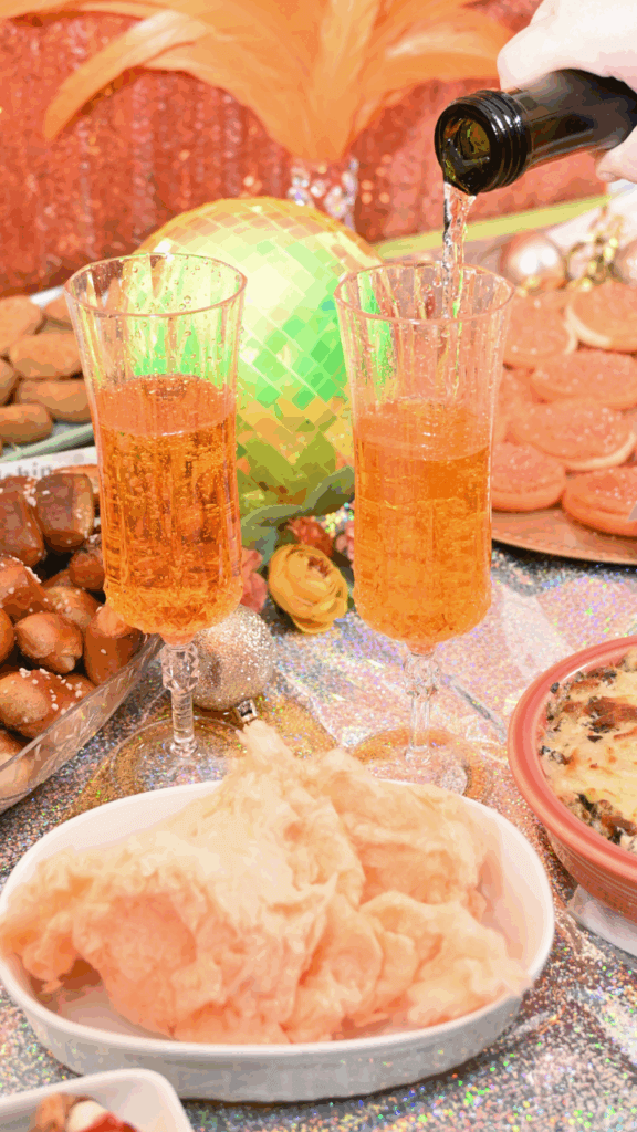 Close up of pouring champagne over cotton candy for this Actually Romantic Champagne Cocktail