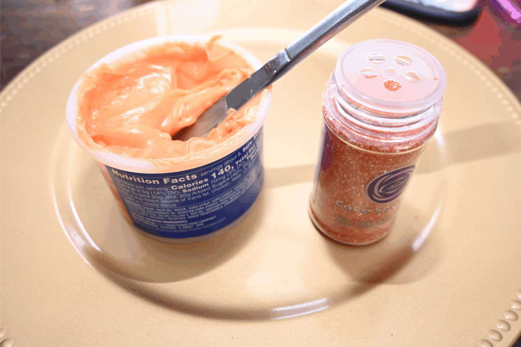 Canned orange frosting and orange sanding sugar. 