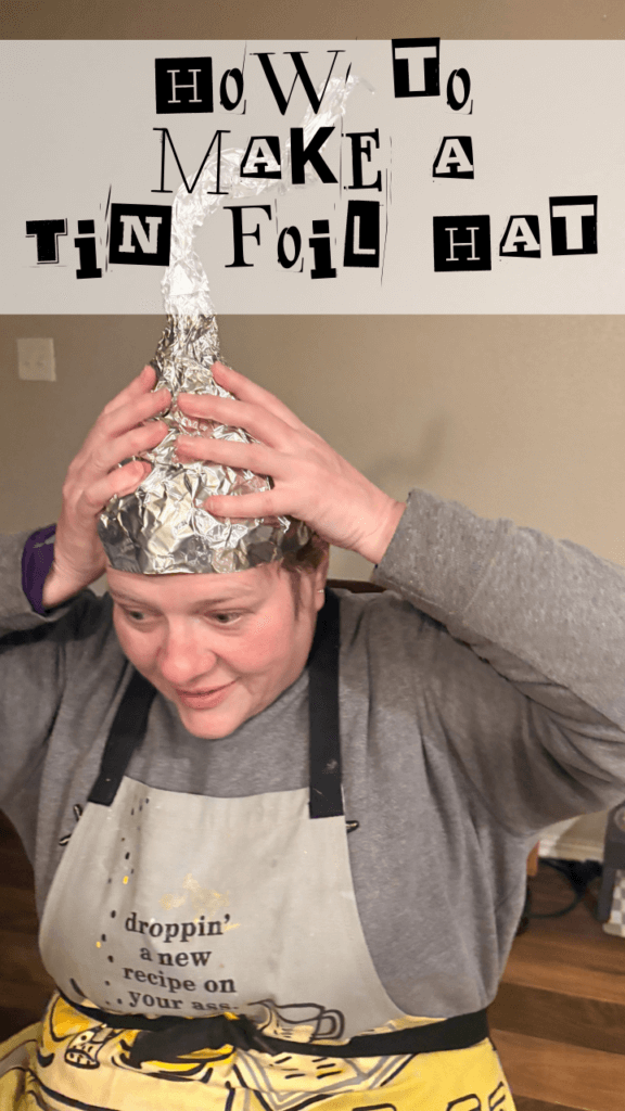 Title image with a woman in a gray sweatshirt and apron holding her head with a tin foil hat 