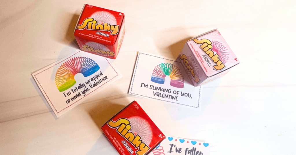 Slinkies with Valentines on a white marble background. 